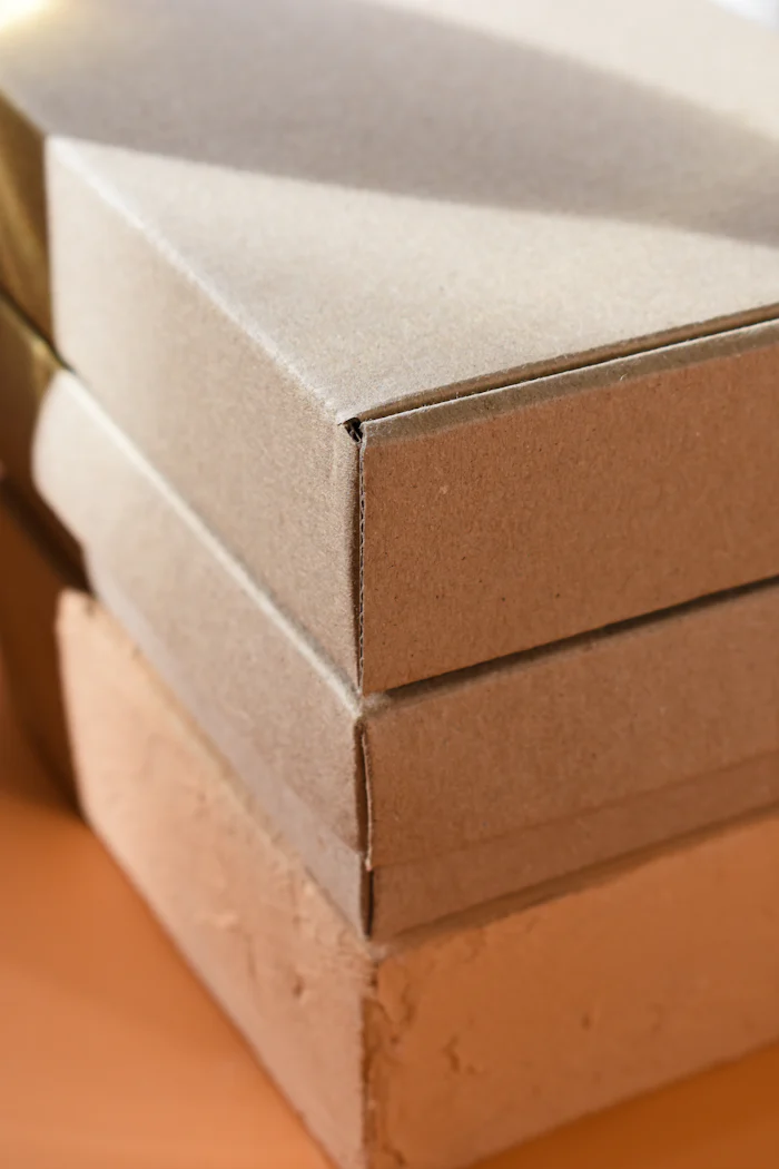Three plain board boxes stacked one on top of another