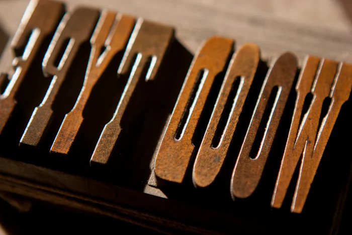 Worn wooden printing type, letters raised on their blocks